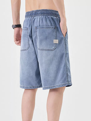 Casual loose fit denim shorts for him in light blue with elastic waistband and back pockets.
