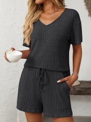 Black ribbed V-neck loungewear set with drawstring shorts and short sleeves.