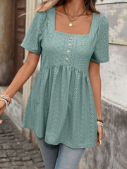 Sky blue eyelet babydoll top with square neck, puff sleeves, and decorative buttons.