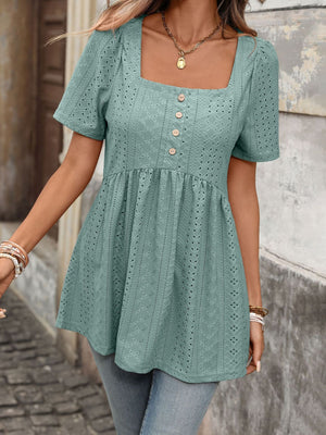 Sky blue eyelet babydoll top with square neck, puff sleeves, and decorative buttons.