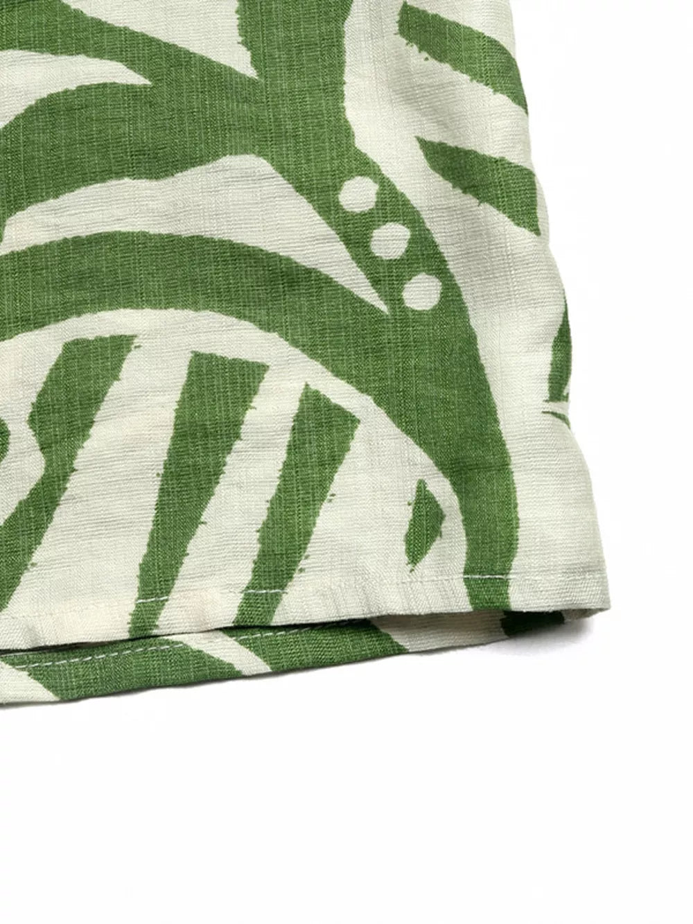 Tropical tie-front strapless jumpsuit in green and white abstract print.