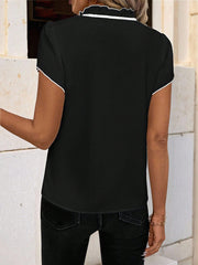 Black maternity blouse with white trim on ruffled tie-neck and short sleeves.