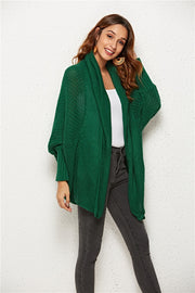Textured cocoon knit cardigan in dark green with batwing sleeves and open front.