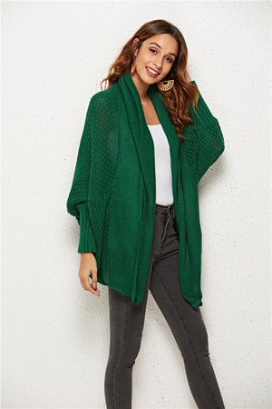 Textured cocoon knit cardigan in dark green with batwing sleeves and open front.
