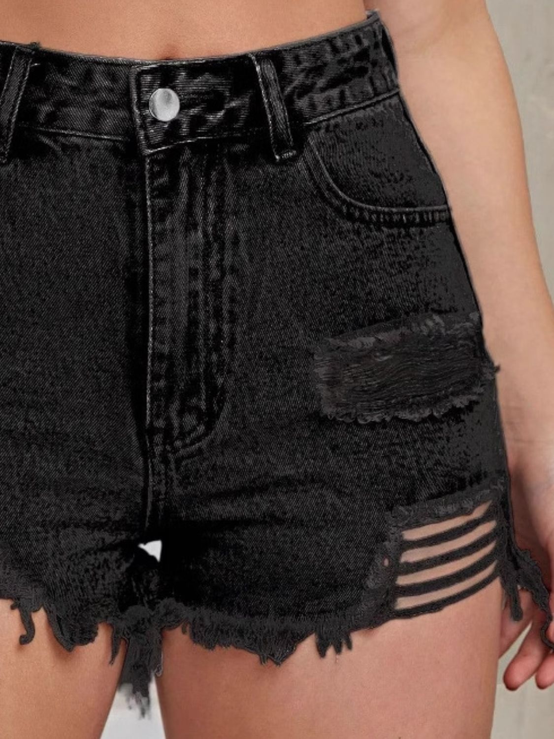 Black distressed denim cutoff shorts with ladder detailing and frayed hem.