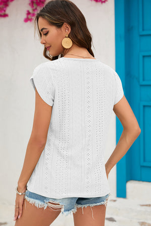 White eyelet cap-sleeve top with keyhole detail and casual cut.