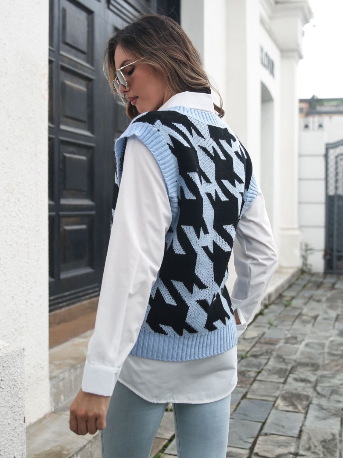 Houndstooth knit v-neck pullover vest in black and misty blue acrylic, styled over a white shirt.