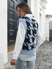 Houndstooth knit v-neck pullover vest in black and misty blue acrylic, styled over a white shirt.
