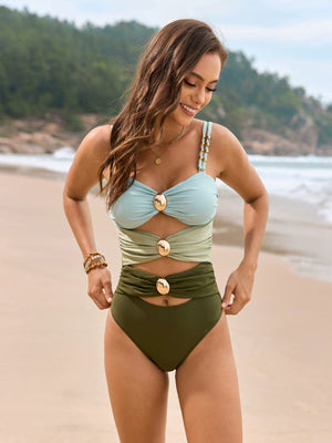 Cutout detail one-piece swimsuit in light blue and olive green with gold hardware and ruching.