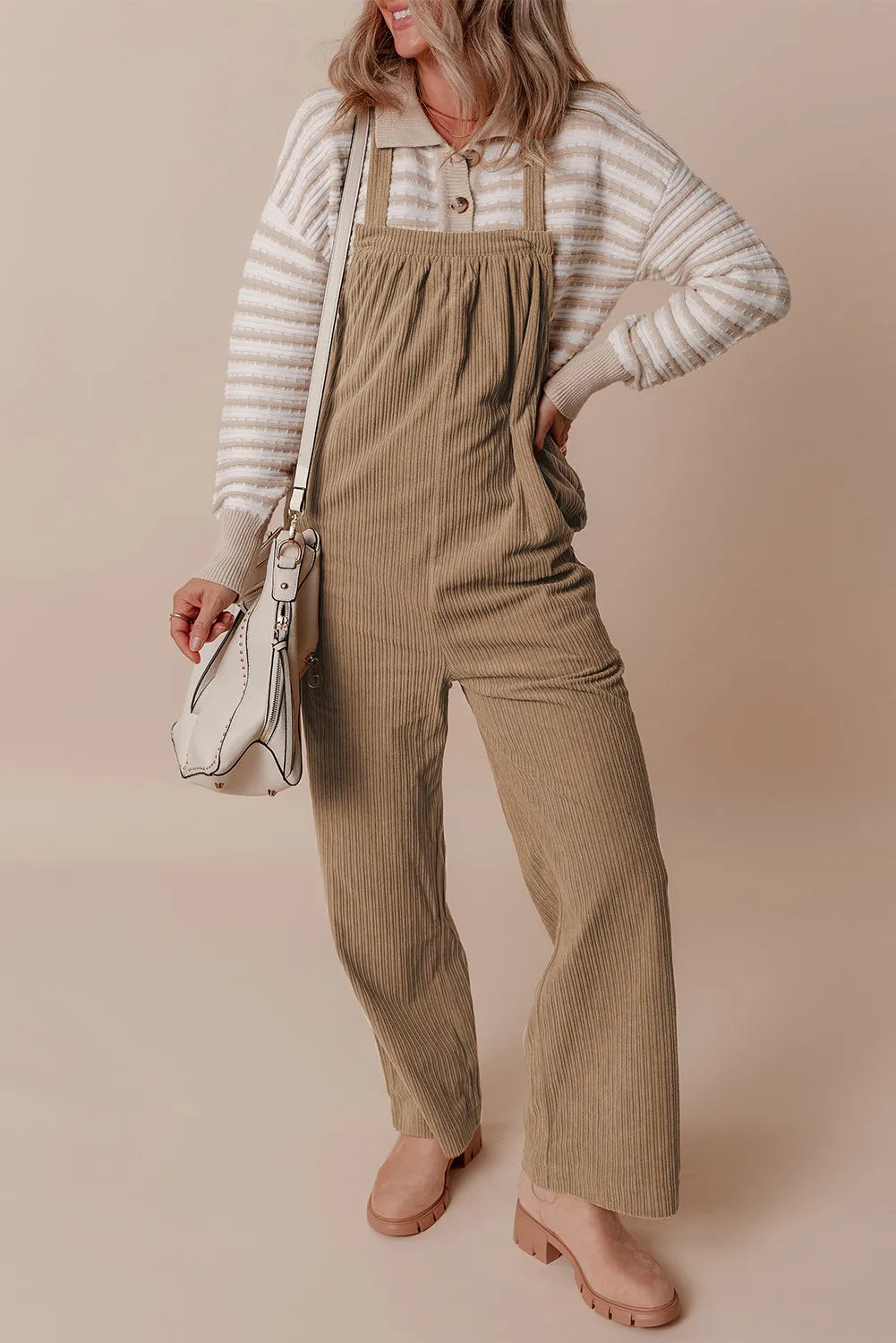 Camel corduroy wide-leg overalls with a bib front and adjustable straps.