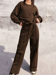 Brown seamed sweatshirt and wide-leg lounge pants set with drawstring waist and crew neck.