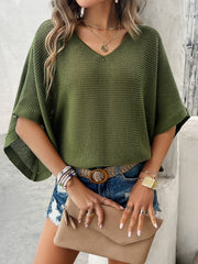 Open-knit dolman sleeve sweater in Matcha Green with a V-neck, styled casually with denim shorts.