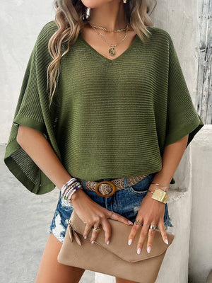 Open-knit dolman sleeve sweater in Matcha Green with a V-neck, styled casually with denim shorts.
