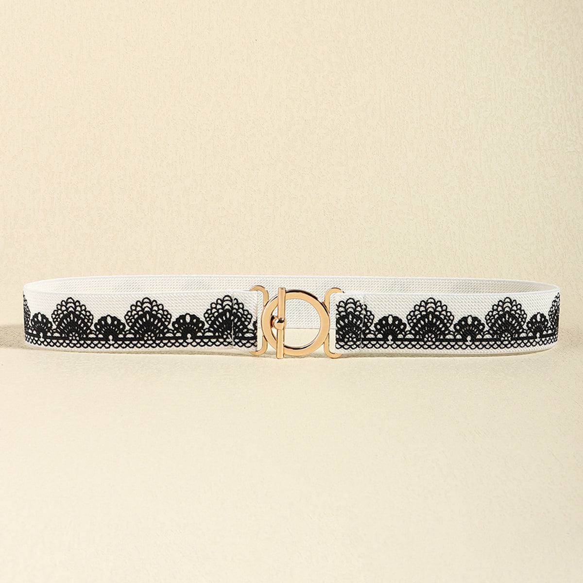 White elastic belt with black lace trim and gold circle buckle
