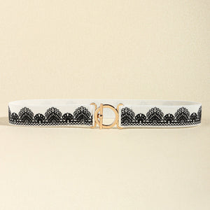 White elastic belt with black lace trim and gold circle buckle