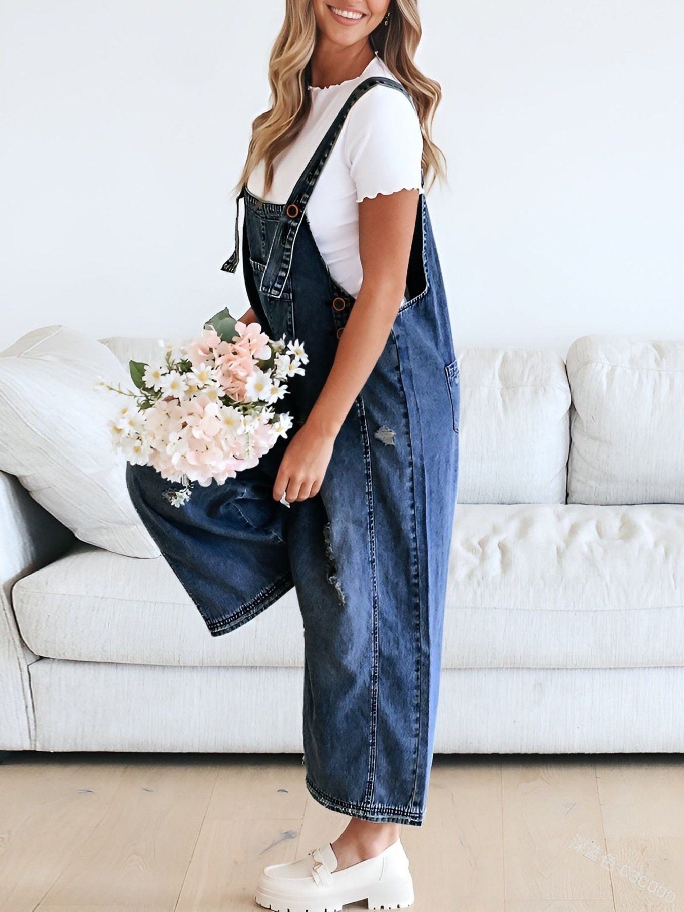 Ripped relaxed fit denim overalls in dark blue, with adjustable straps and distressed details.
