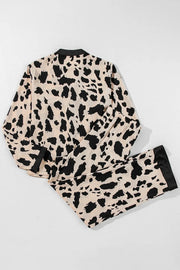 Animal print satin pajama set with black trim and buttoned top.