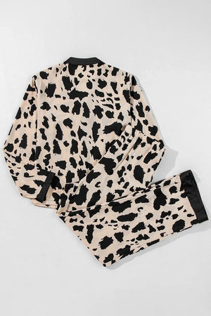 Animal print satin pajama set with black trim and buttoned top.