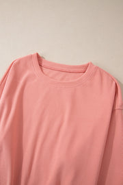 Pink corduroy loungewear set with crewneck top and relaxed fit.