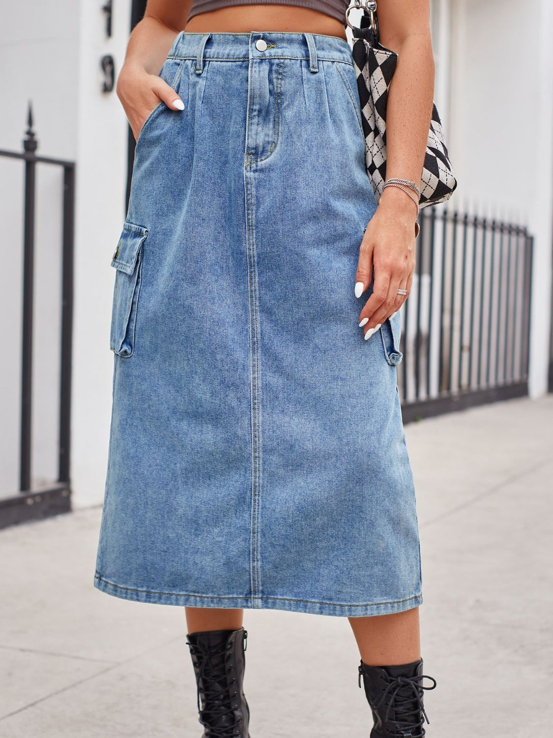 Light wash denim midi skirt with cargo pockets and a front slit