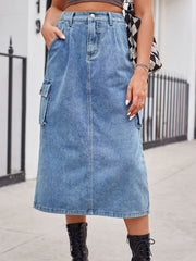 Light wash denim midi skirt with cargo pockets and a front slit