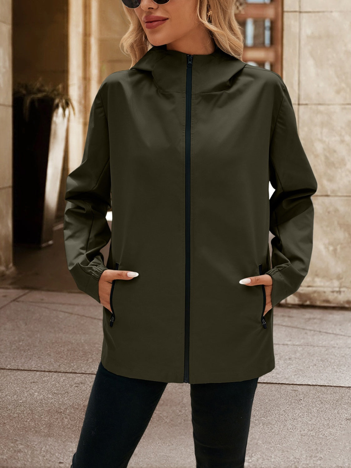 Army green zip-through hooded jacket with zippered pockets.