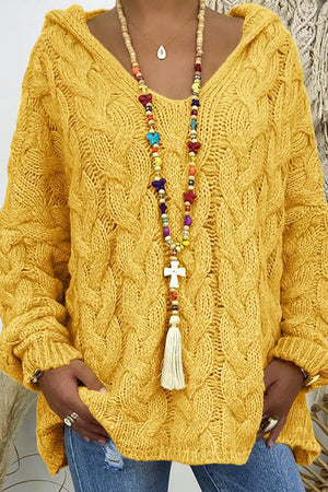 Yellow cable knit hooded cocoon sweater with a V-neck and textured sleeves.