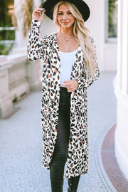 Leopard print duster cardigan with long sleeves and pockets, styled with a white tank and black pants.