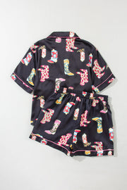 Black silk pajama set with colorful cowboy boot print and pink piping.