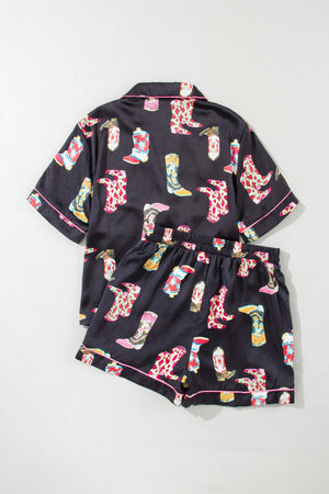 Black silk pajama set with colorful cowboy boot print and pink piping.