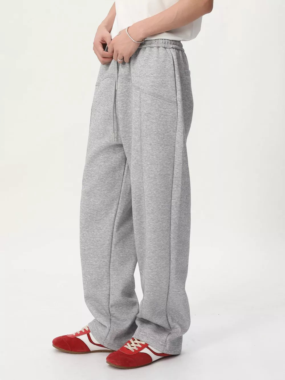 Gray cotton drawstring sweatpants with wide legs and a tailored fit.