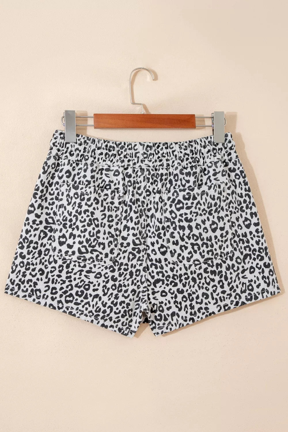 Denim skort with black and white leopard print, elastic waist, and pockets.