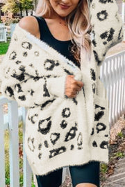 Leopard print plush open cardigan with pockets and fuzzy texture.