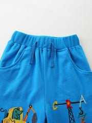 Blue cotton toddler boys' pants with embroidered construction vehicles and crane.