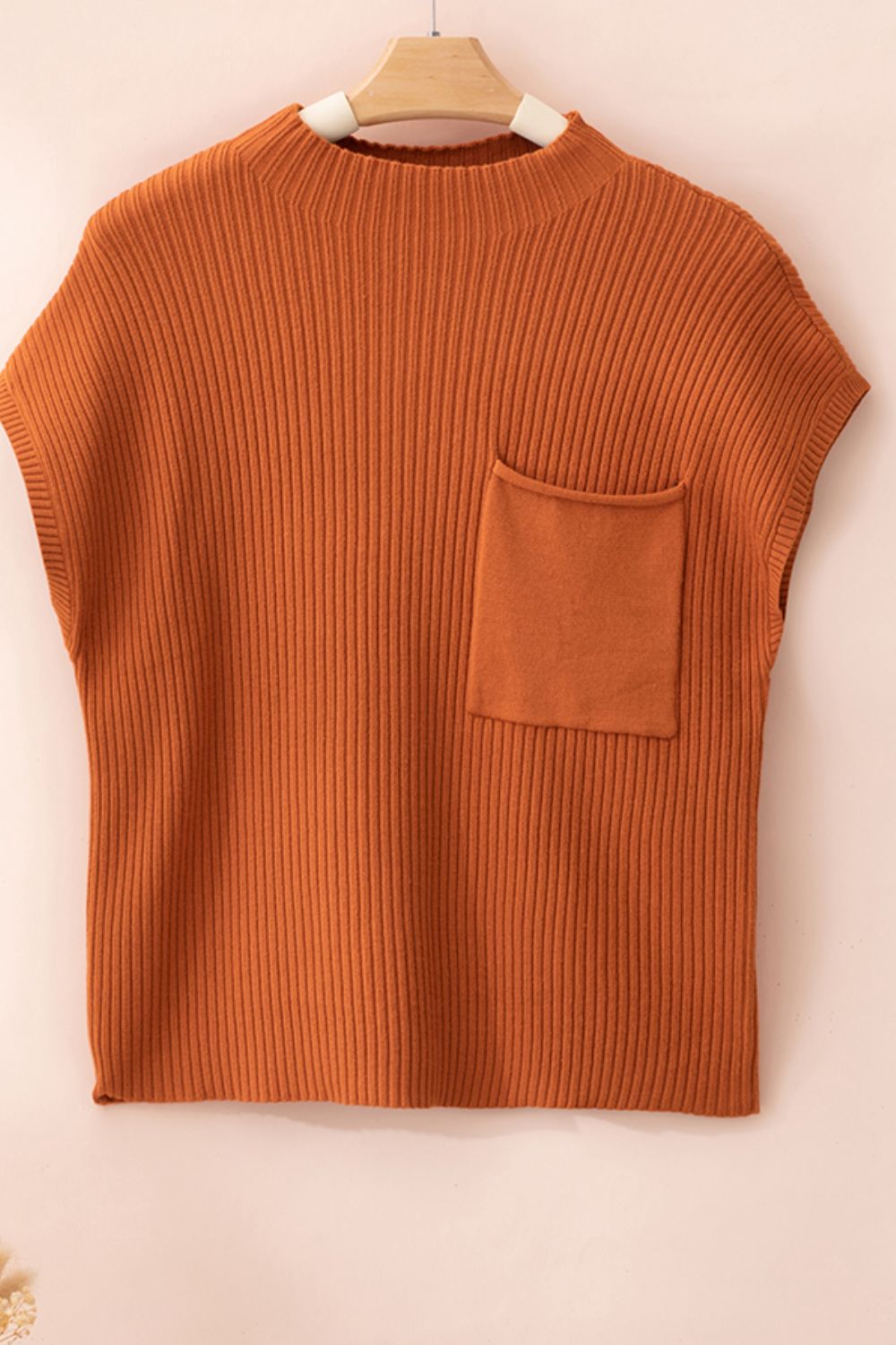 Caramel ribbed knit mock neck top with a chest pocket.