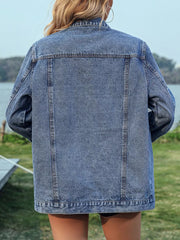 Blue denim trucker jacket with button-up front and chain fringe detail on back.