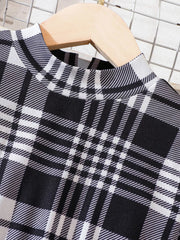 Black and white plaid baby dress with mock neck and long sleeves.