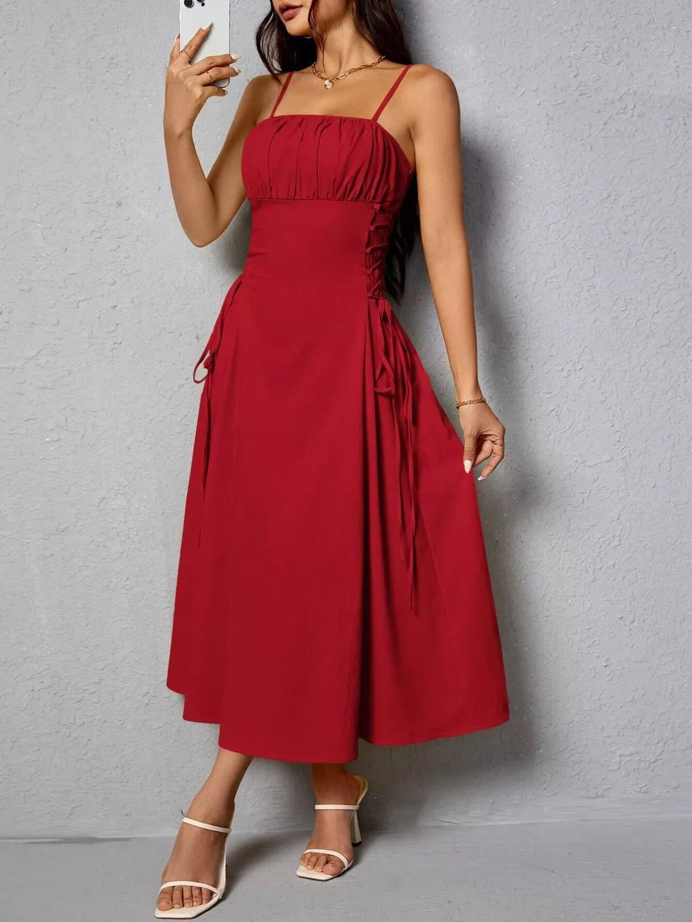 Deep red cami dress with ruched bodice and crisscross lace-up sides.