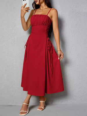 Deep red cami dress with ruched bodice and crisscross lace-up sides.
