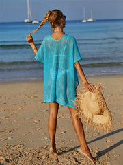 Sky blue crochet beach cover-up with daisy appliqué, V-neck, short sleeves.