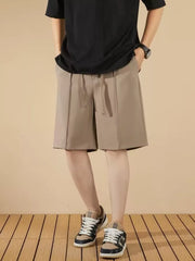 Men's khaki chino shorts with drawstring and pleats, cotton blend, casual style.