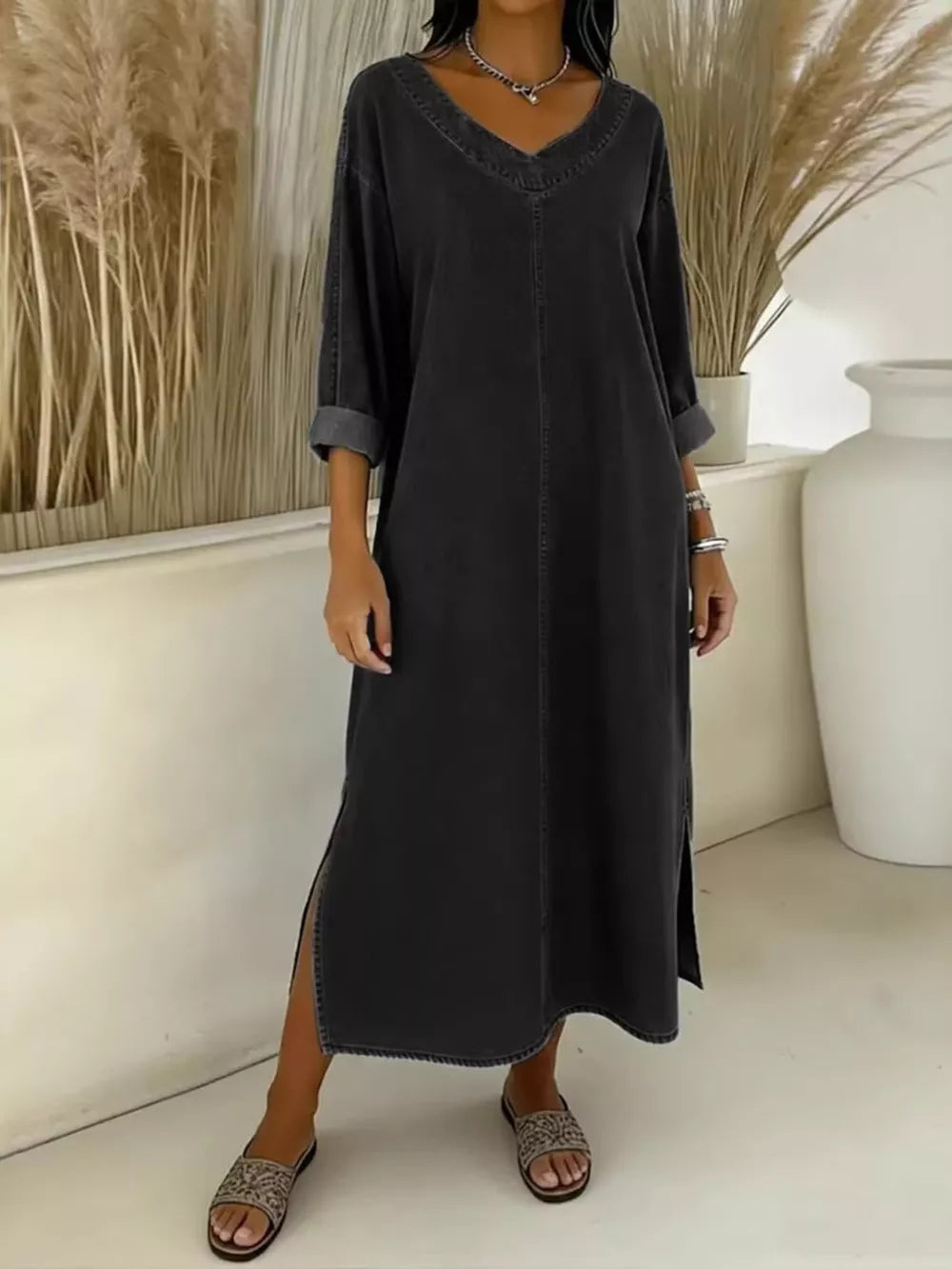 Dark blue midi dress with V-neck, long sleeves, and side slits.