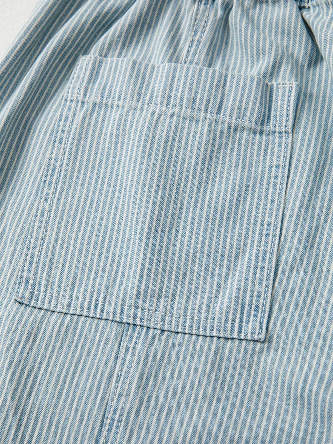 Light blue striped denim jeans with drawstring waist and back pocket detail.