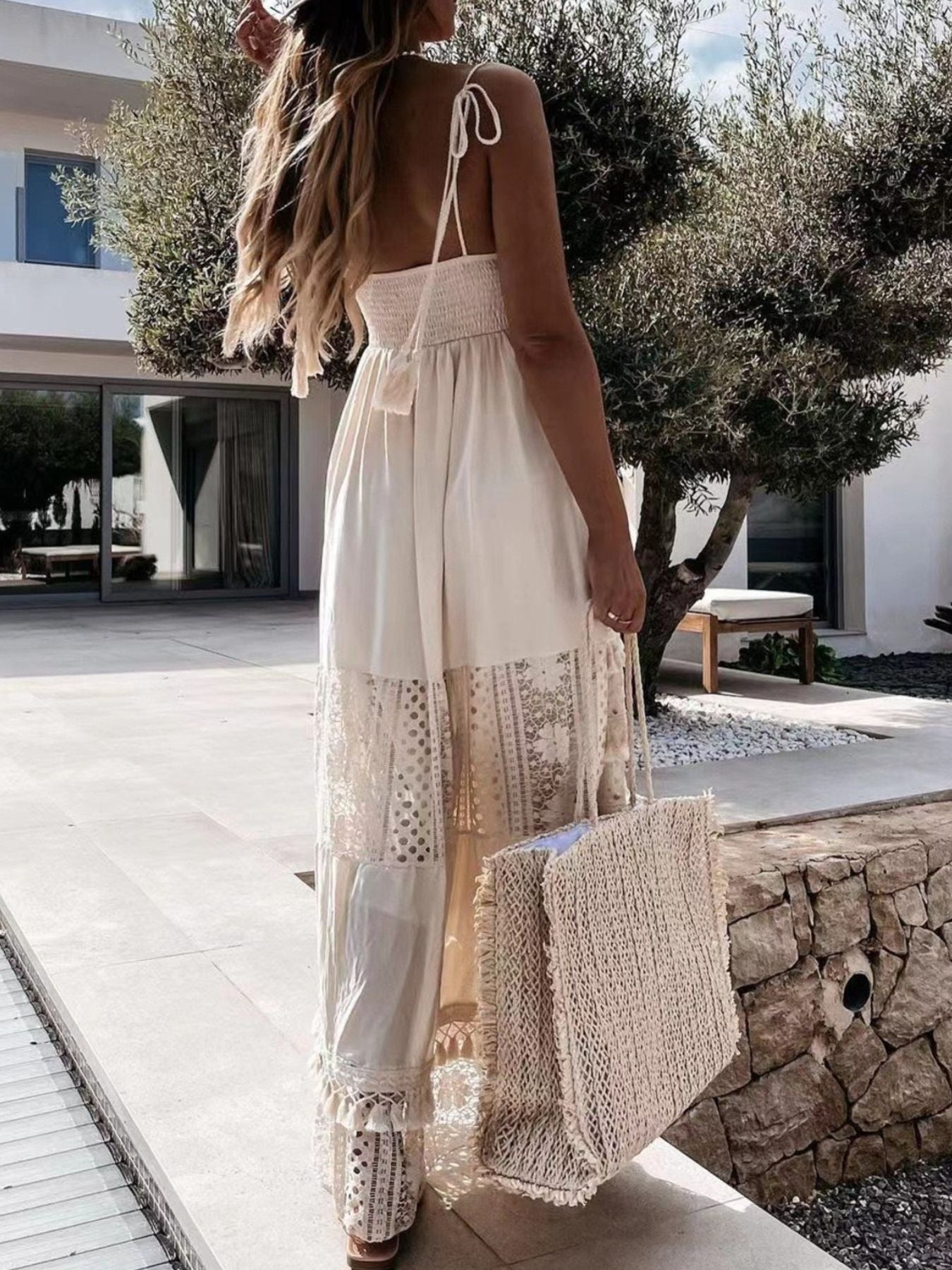 Bohemian crochet cami dress in white with tiered lace panels and tassels.