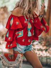 Red embroidered off-shoulder ruffled sleeve shirt with bohemian details.