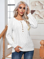 White cable knit henley sweater with button detail and diamond pattern.