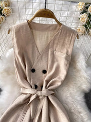 Chic V-neck wide leg jumpsuit in apricot with double-breasted buttons and belted waist.