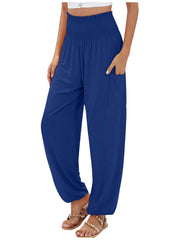 Blue smocked waist harem pants with pockets and ankle cuffs.