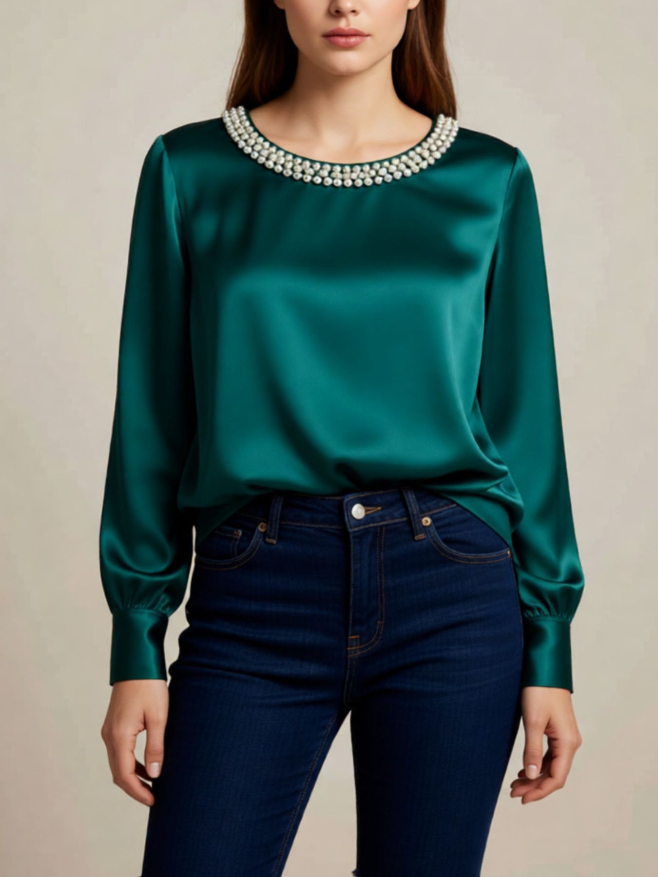 Green satin blouse with pearl trim round neckline and long sleeves.