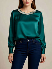 Green satin blouse with pearl trim round neckline and long sleeves.